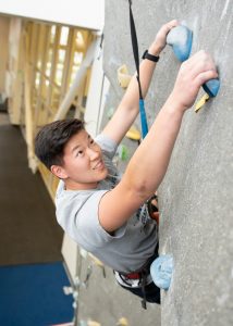 student on a climbing wall