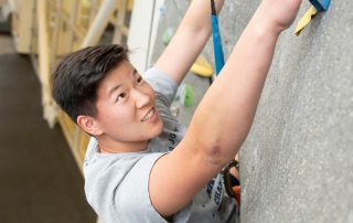 student on a climbing wall