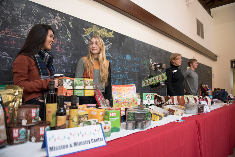 Students working at a booth during Christmas selling fair trade products