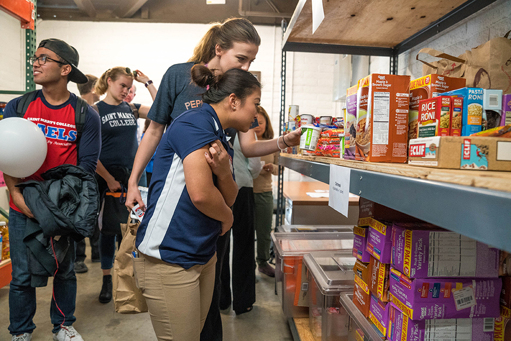 Students in the Gael Pantry looking on food on a shelf