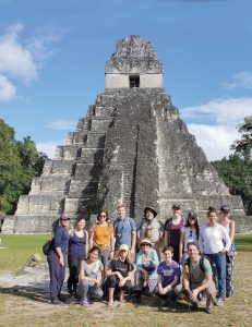 Students lined up for a group photo in front of a temple in Guatemala