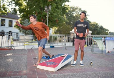 Students on the chapel lawn playing sock toss and laughing