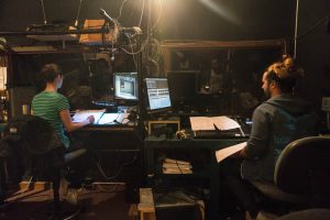 Students working back stage in audio and lighting at a performance in LeFevre Theatre